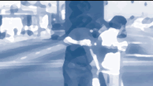 Abstract photo of 2 men cleaning up a street.