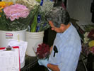 Photo of an inspector inspecting flowers.