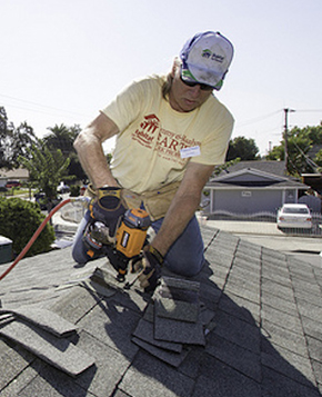 Photo of a worker repairing roof.
