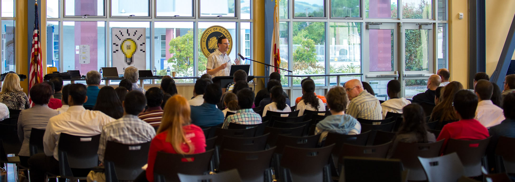 Photo of hackathon participants pitching their app ideas.