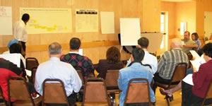 Photograph of people in a meeting.