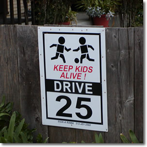 Photo of a sign warning drivers to slow down for children playing.