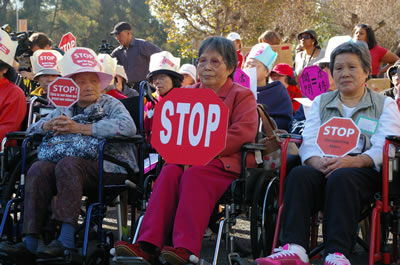 Older citizens attend a rally against busget cuts.