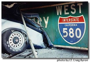 Photo of car damaged by fallen freeway sign.