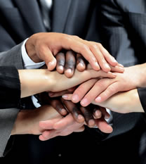 Photo of business people putting their hands together as a team..
