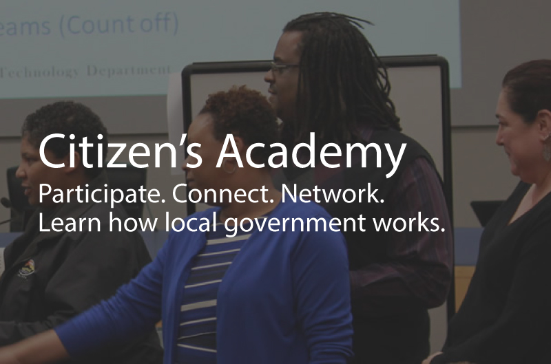Photo showing people at the citizens academy. Caption: Citizen's Academy. Participate. Connect. Network. Learn how local government works.