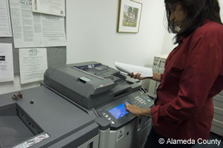 Photo of employee at copy machine.