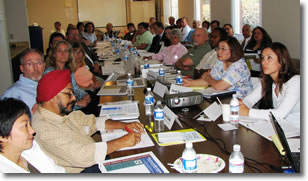 Photo of a group of people meeting around a table.