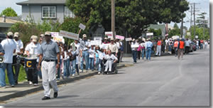 Photo of a group of people rallying on street.
