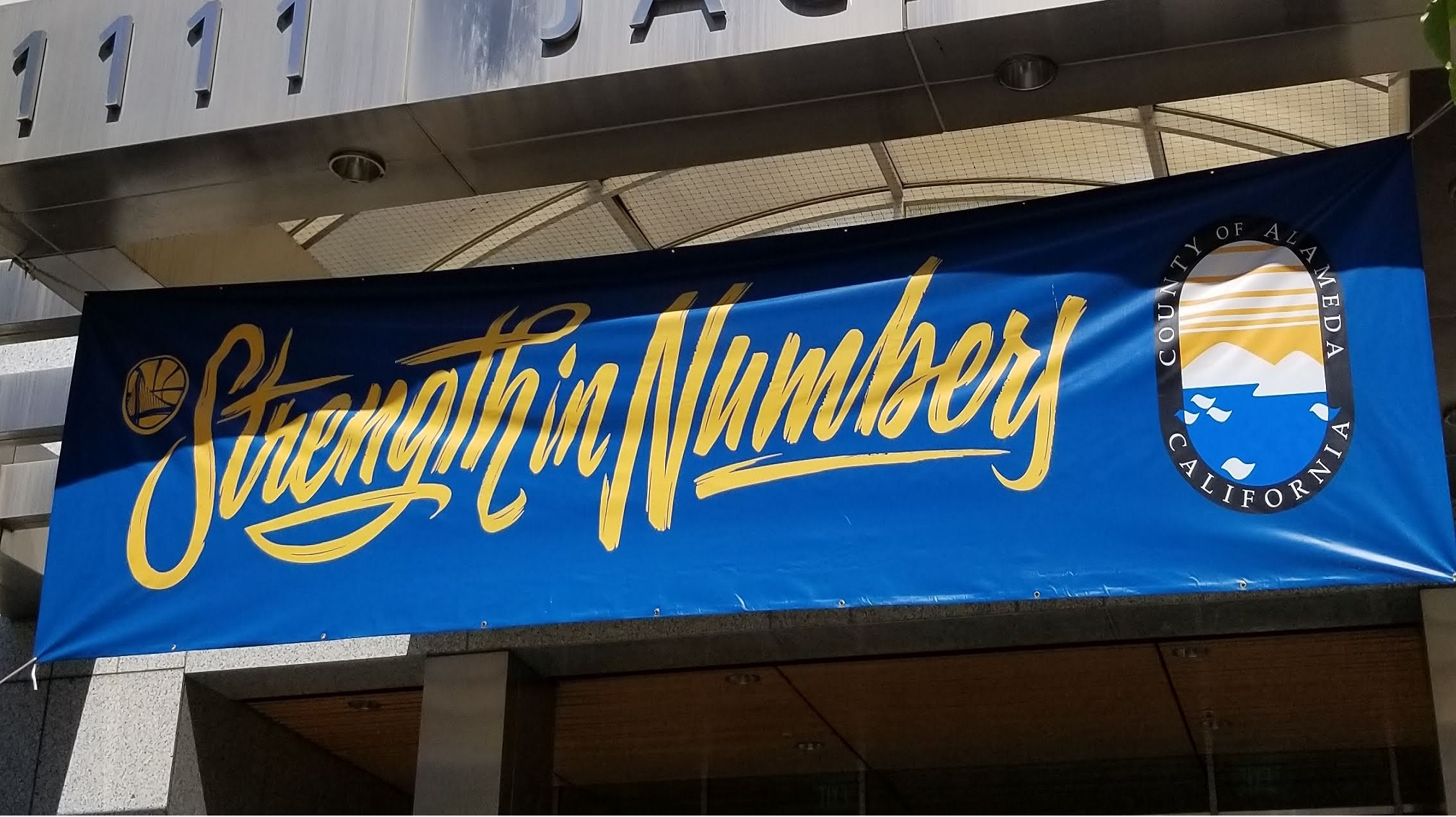 Photograph of County Buildings with banners and lights depicting support for the Golden State Warriors