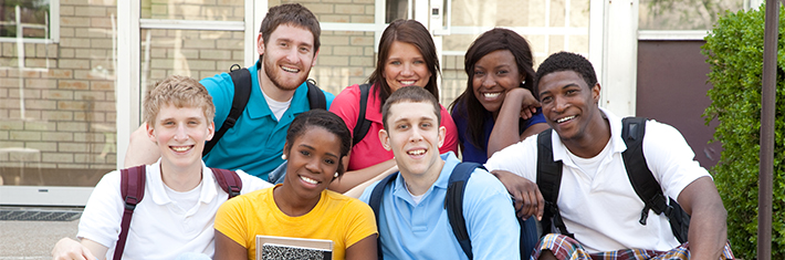 Photograph of seven highschool/college age kids with backpacks on