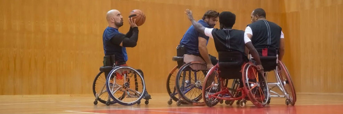 Men in wheelchairs playing basketball