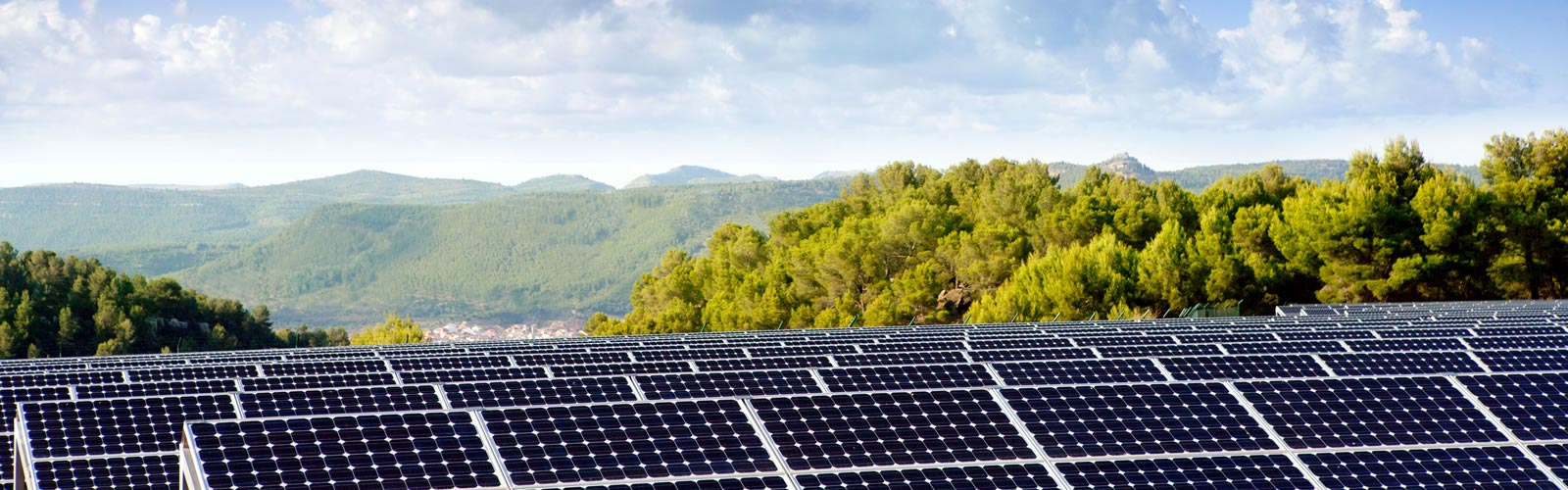 Picture of solar panels with hills in the background