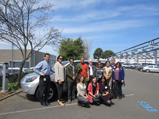 Photo of green ambassadors in front of an electric car.
