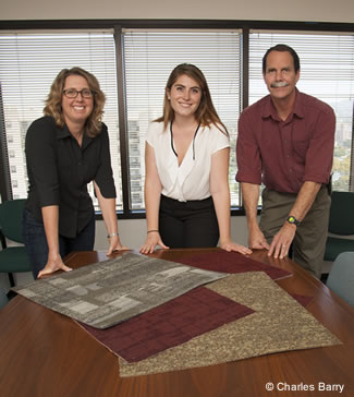 Photo of employees looking over carpet samples.