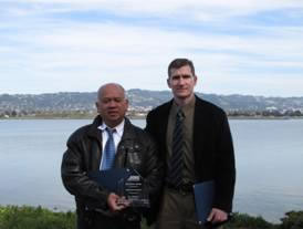 Photo shows project engineers Marvin Montoya and Paul Modrell receiving award.
